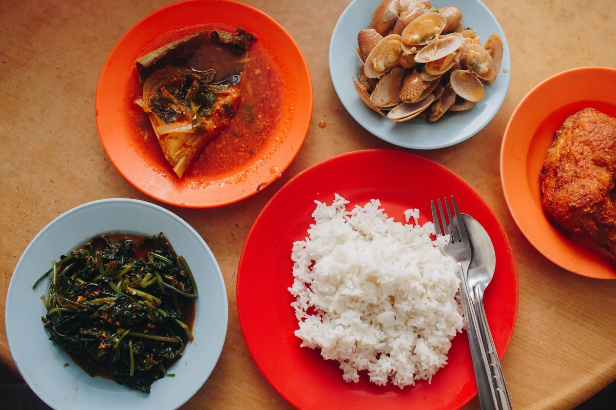 Economy rice spread with lala, kangkung and curry fish