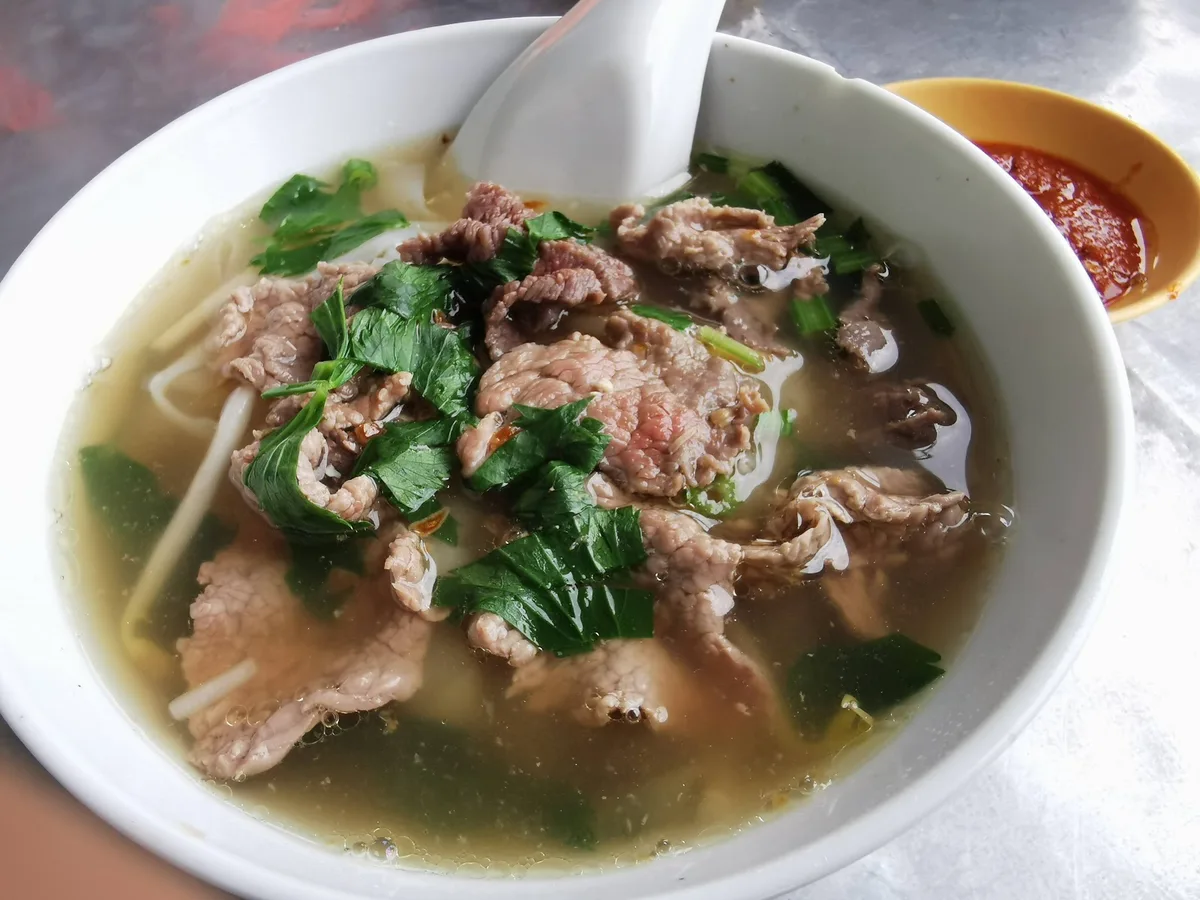 Beef koay teow soup with greens