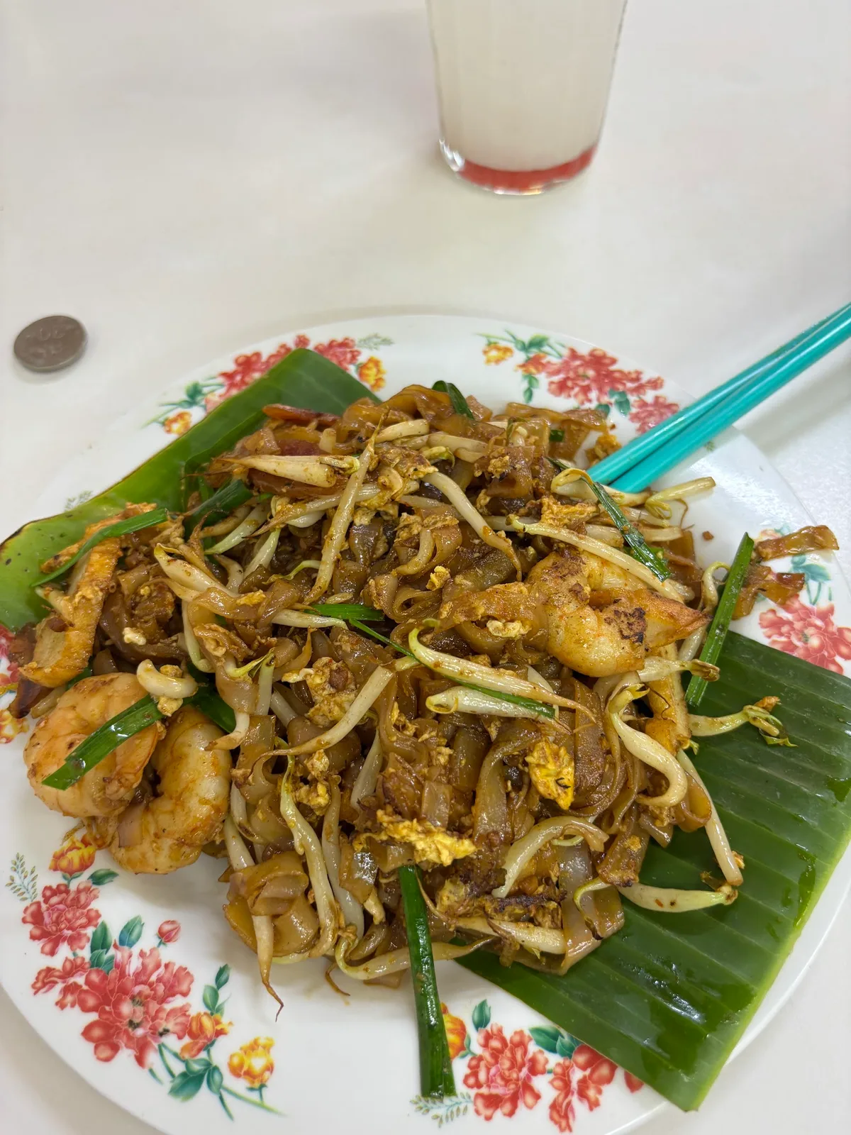 Char koay teow on banana leaf with prawns and bean sprouts