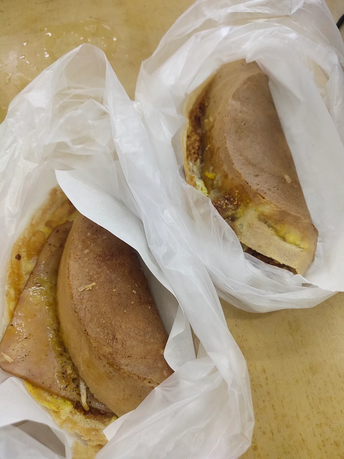 Two folded apam balik bagged for takeaway