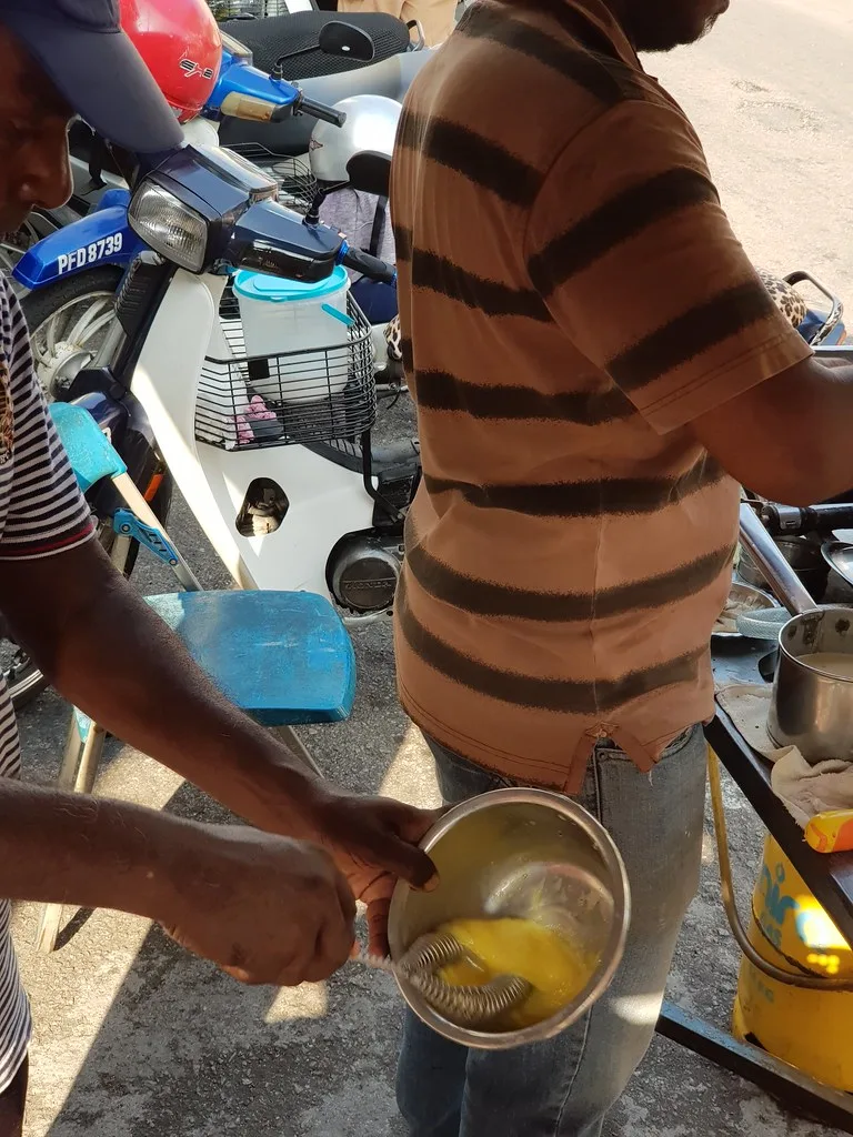 Pouring apom batter