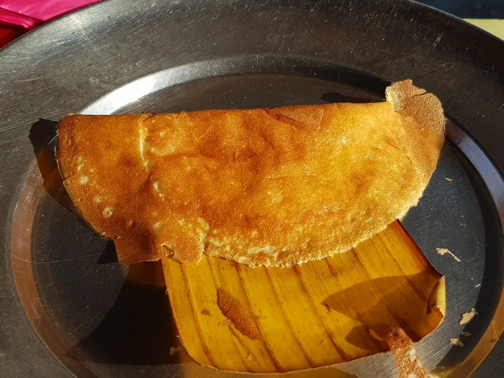 Golden folded apom on the griddle