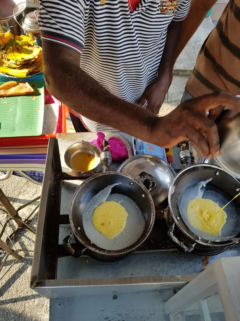 Apom cooking in the moulds