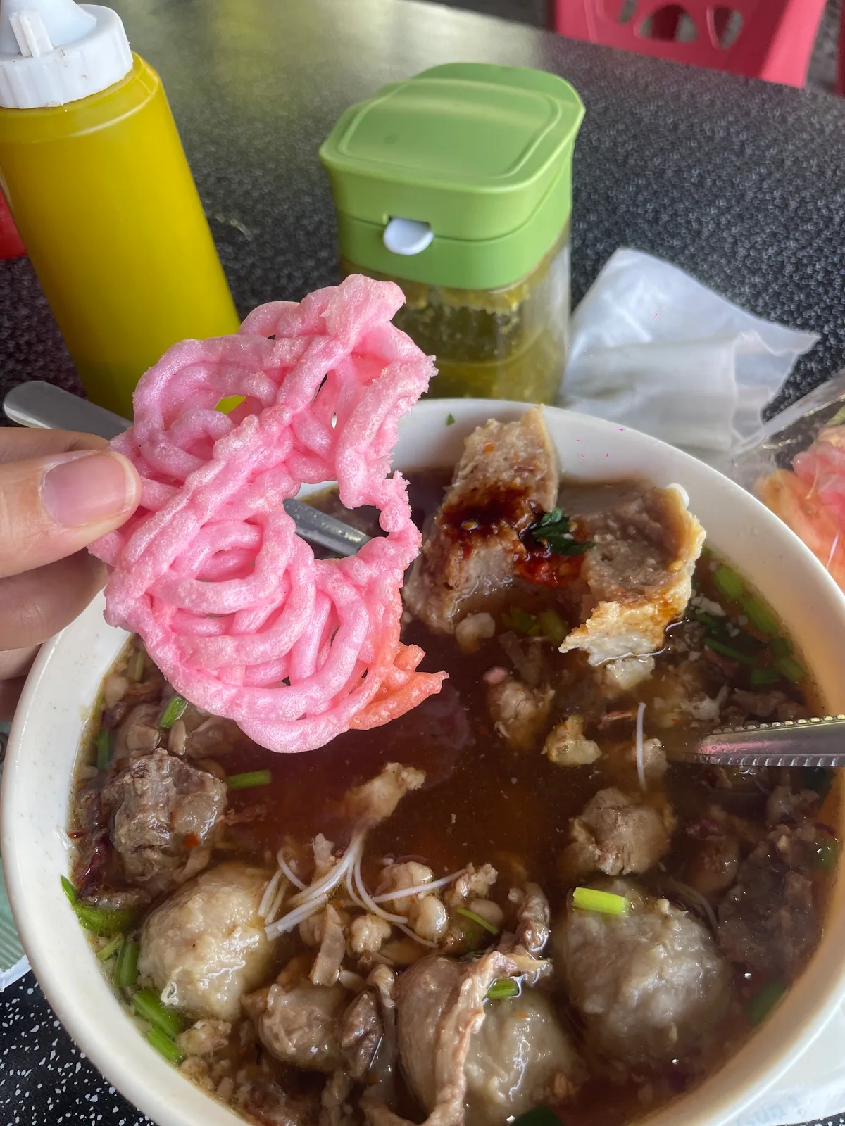 Bakso served with pink kerupuk on the side