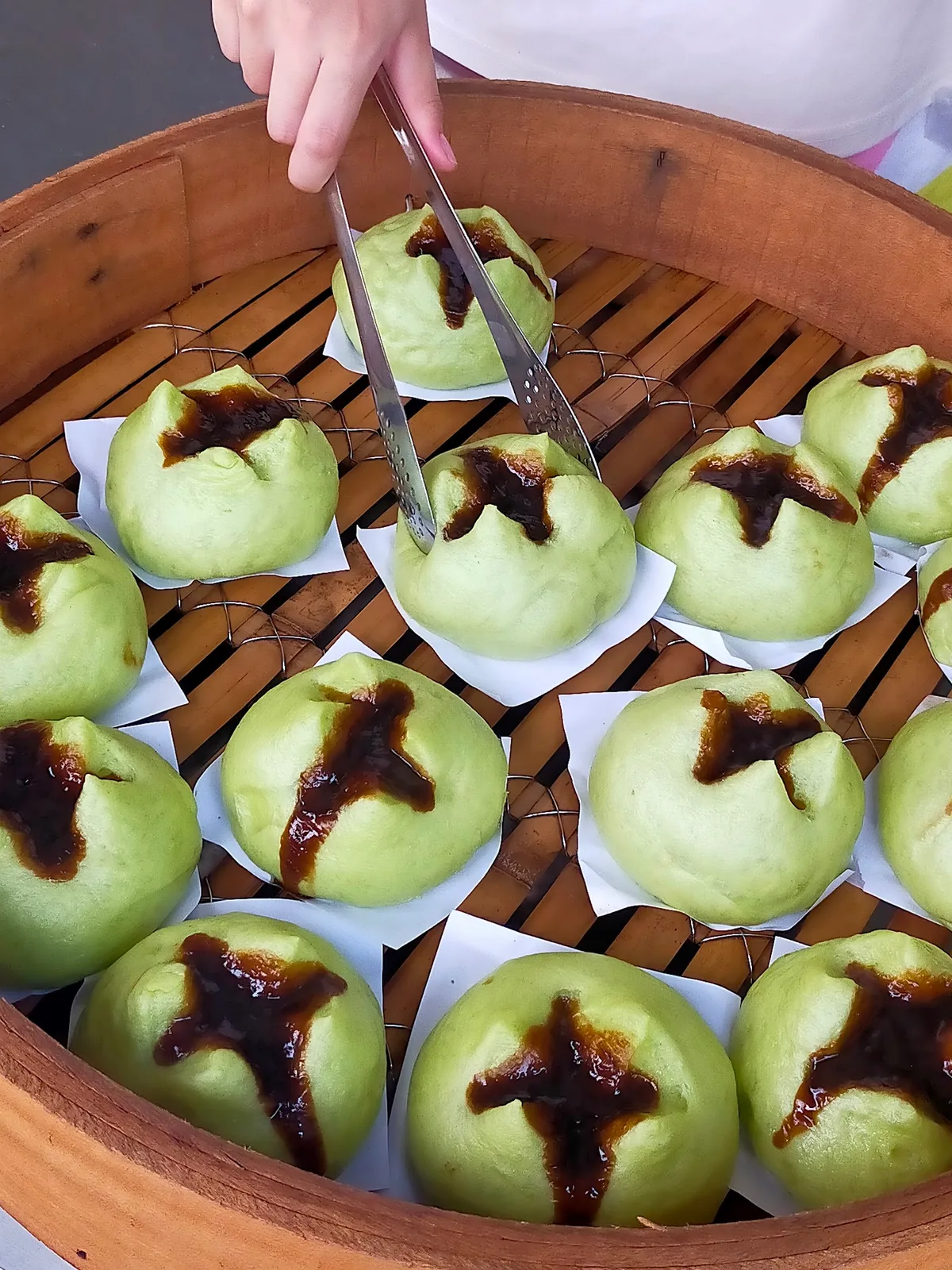 Pandan brown sugar pao lifted from the steamer