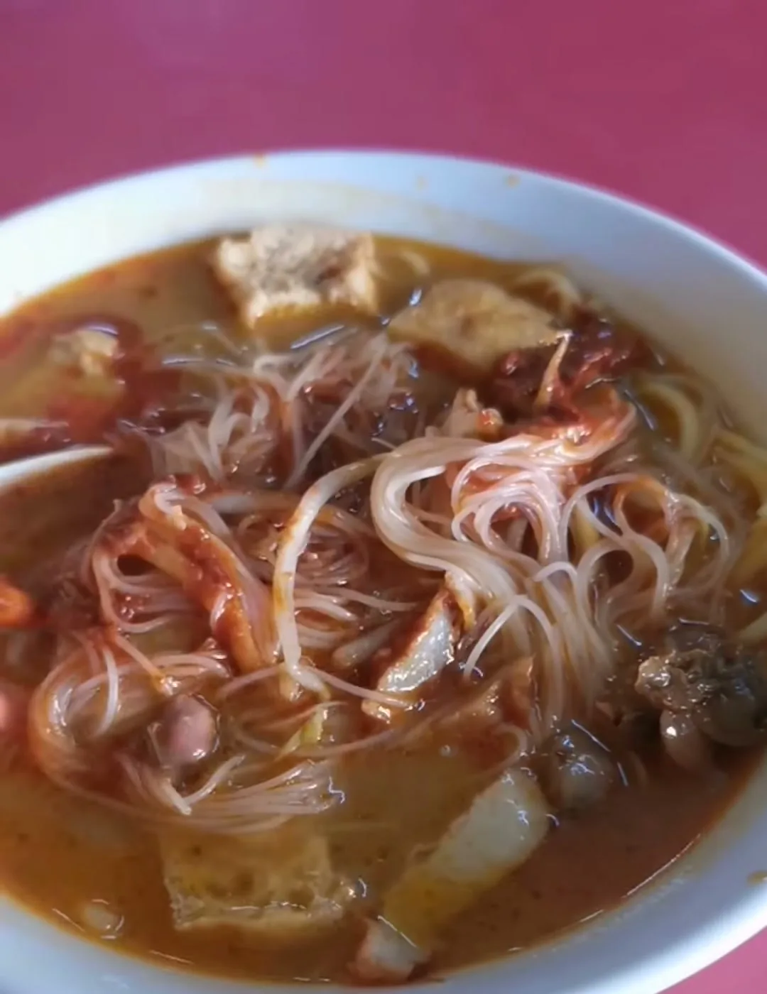 Batu Lanchang Curry Mee bowl with tofu puffs, cockles and vermicelli