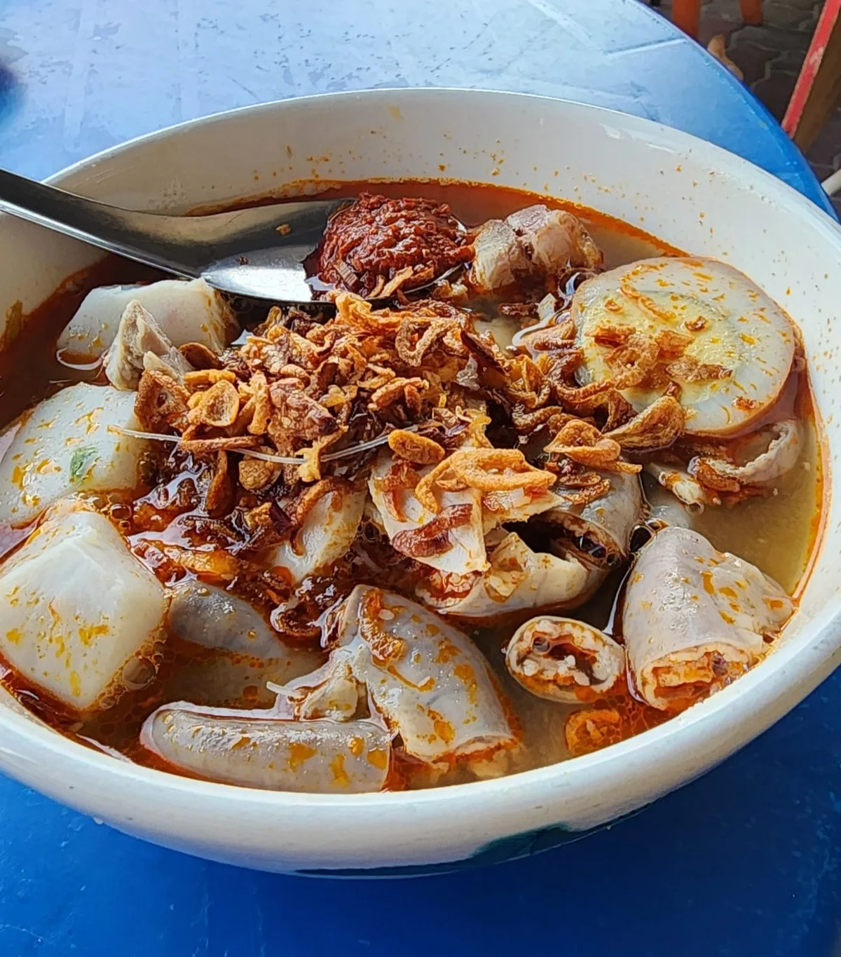 Hokkien mee loaded with intestines and pork in red prawn broth