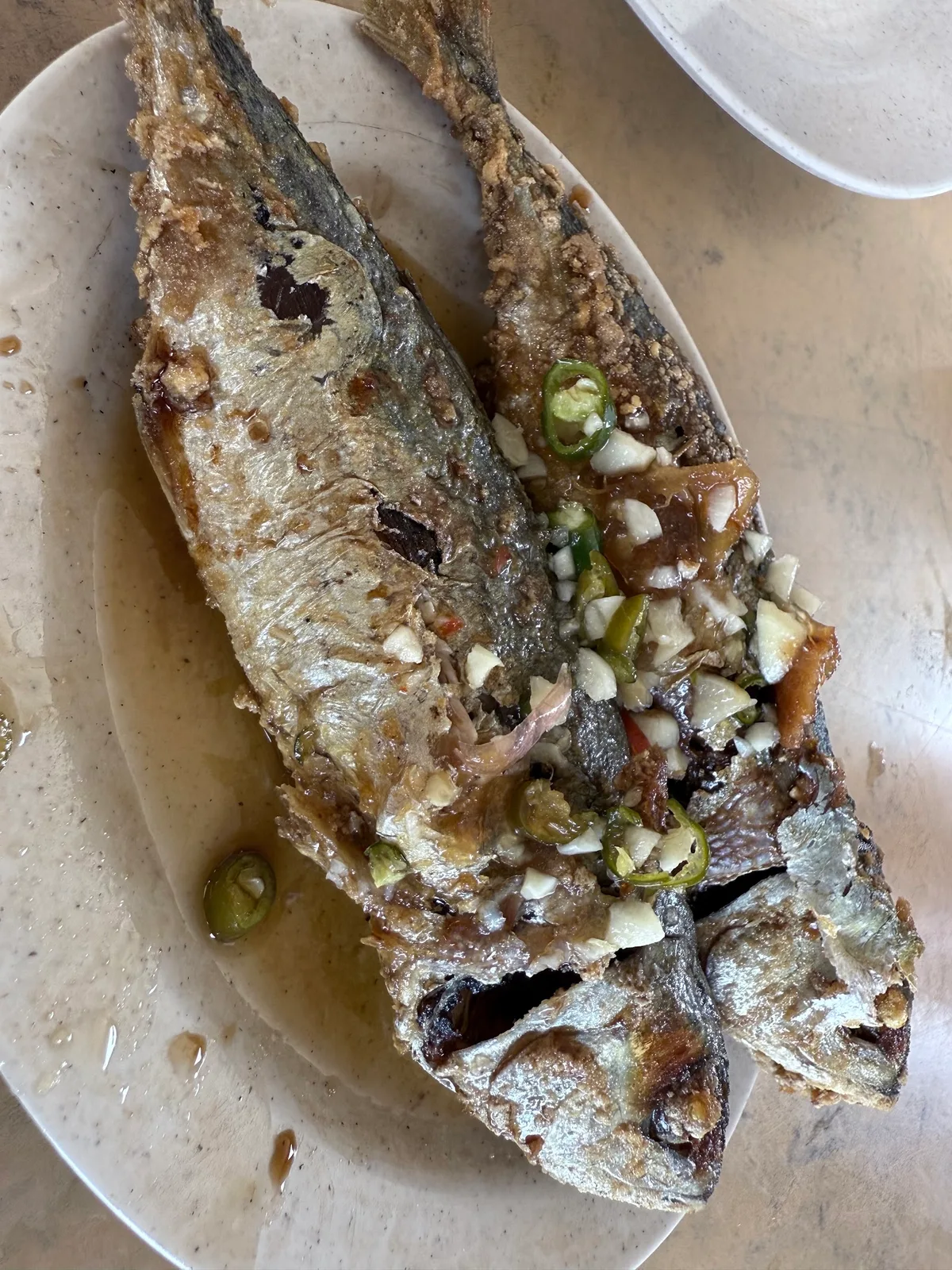 Fried asam fish with garlic and chili