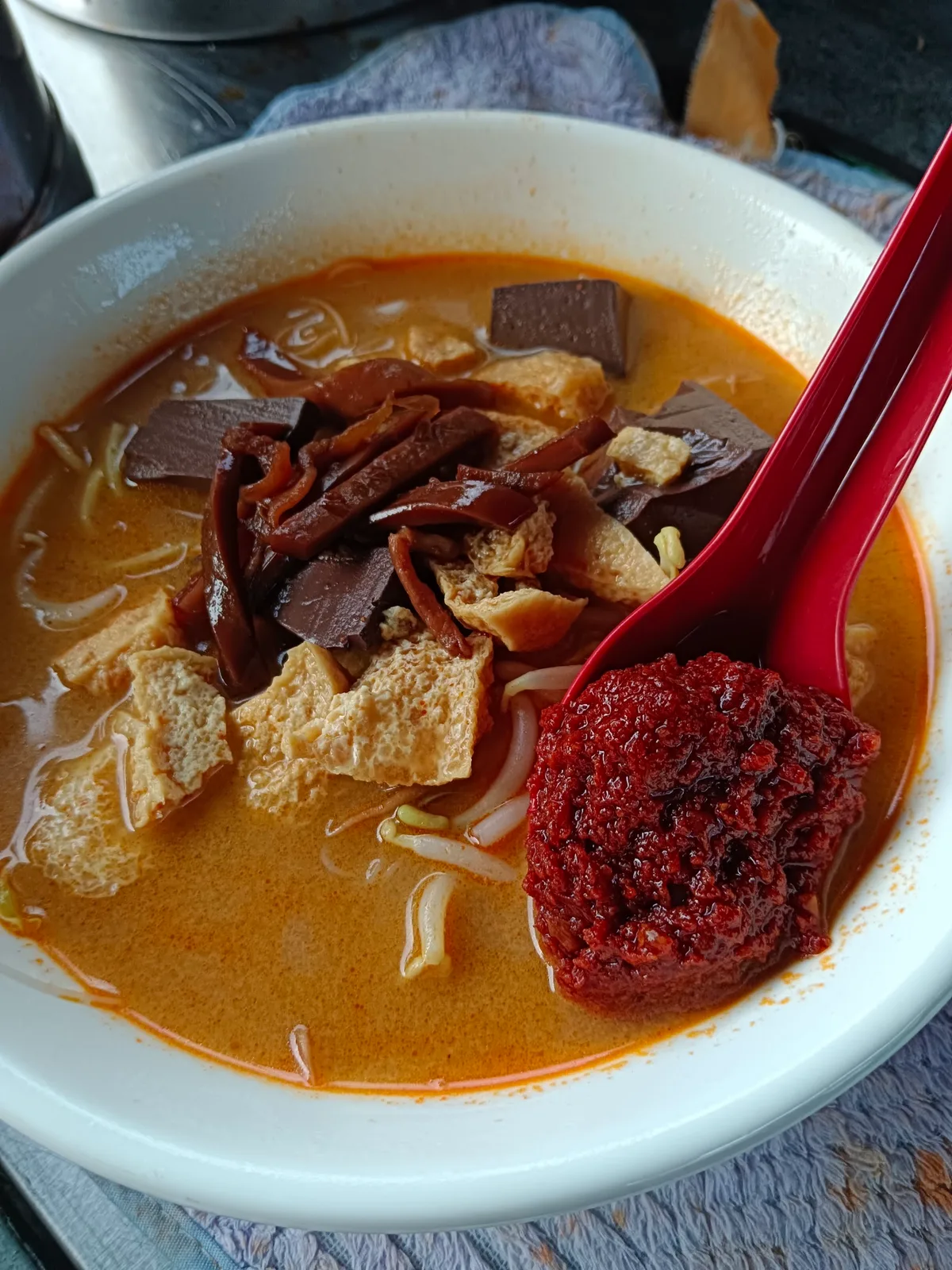 Curry mee with a spoon of sambal
