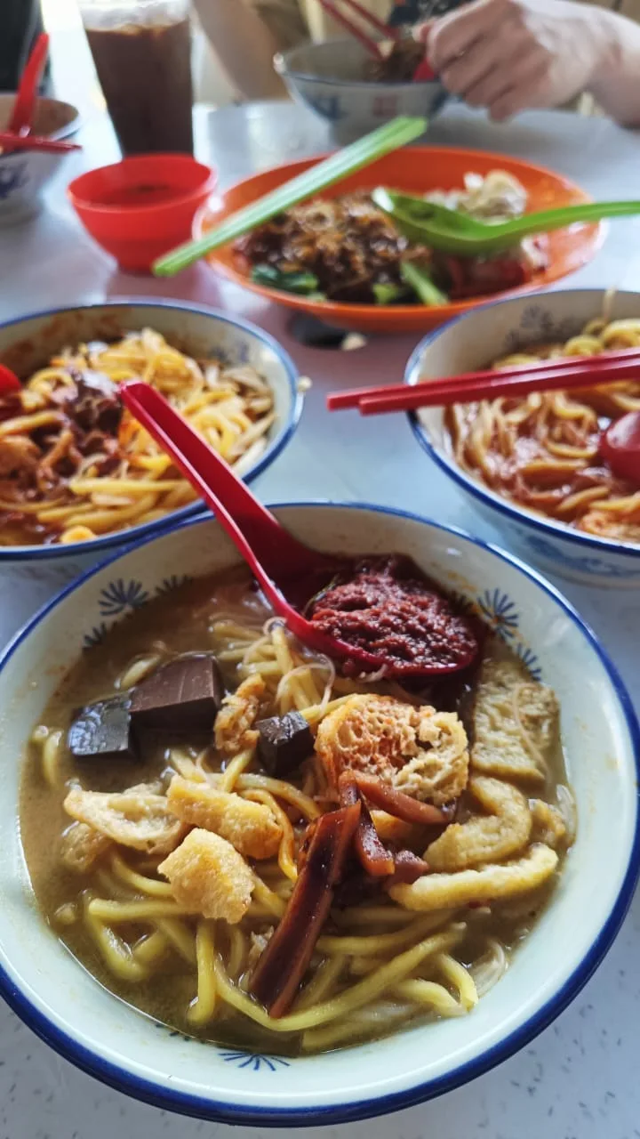 Bowls of curry mee on the table