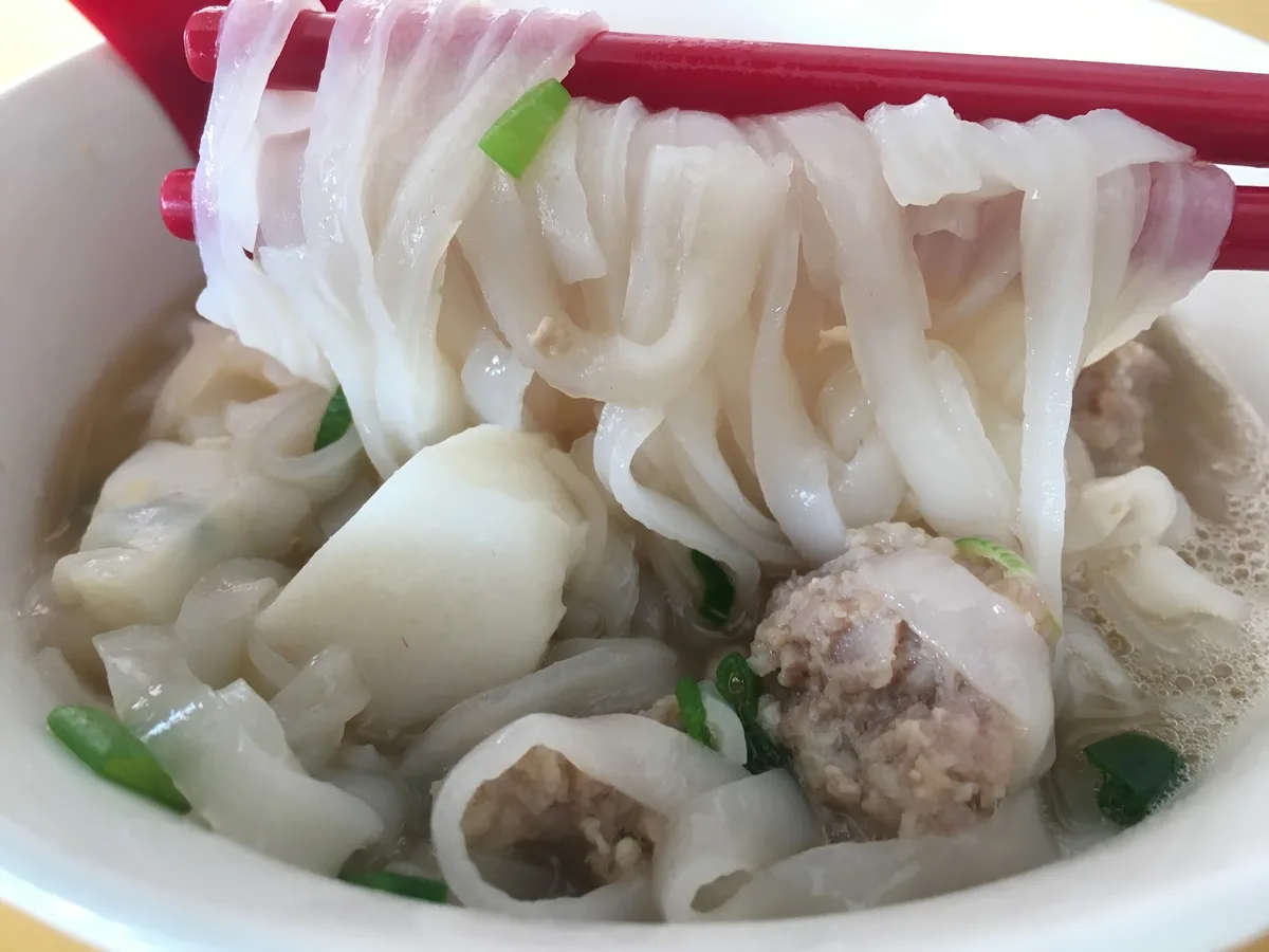 Flat rice noodles with fish balls in clear soup