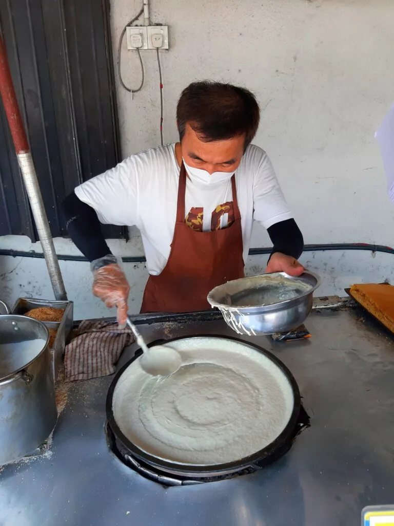 Making ban chang kuih on the griddle
