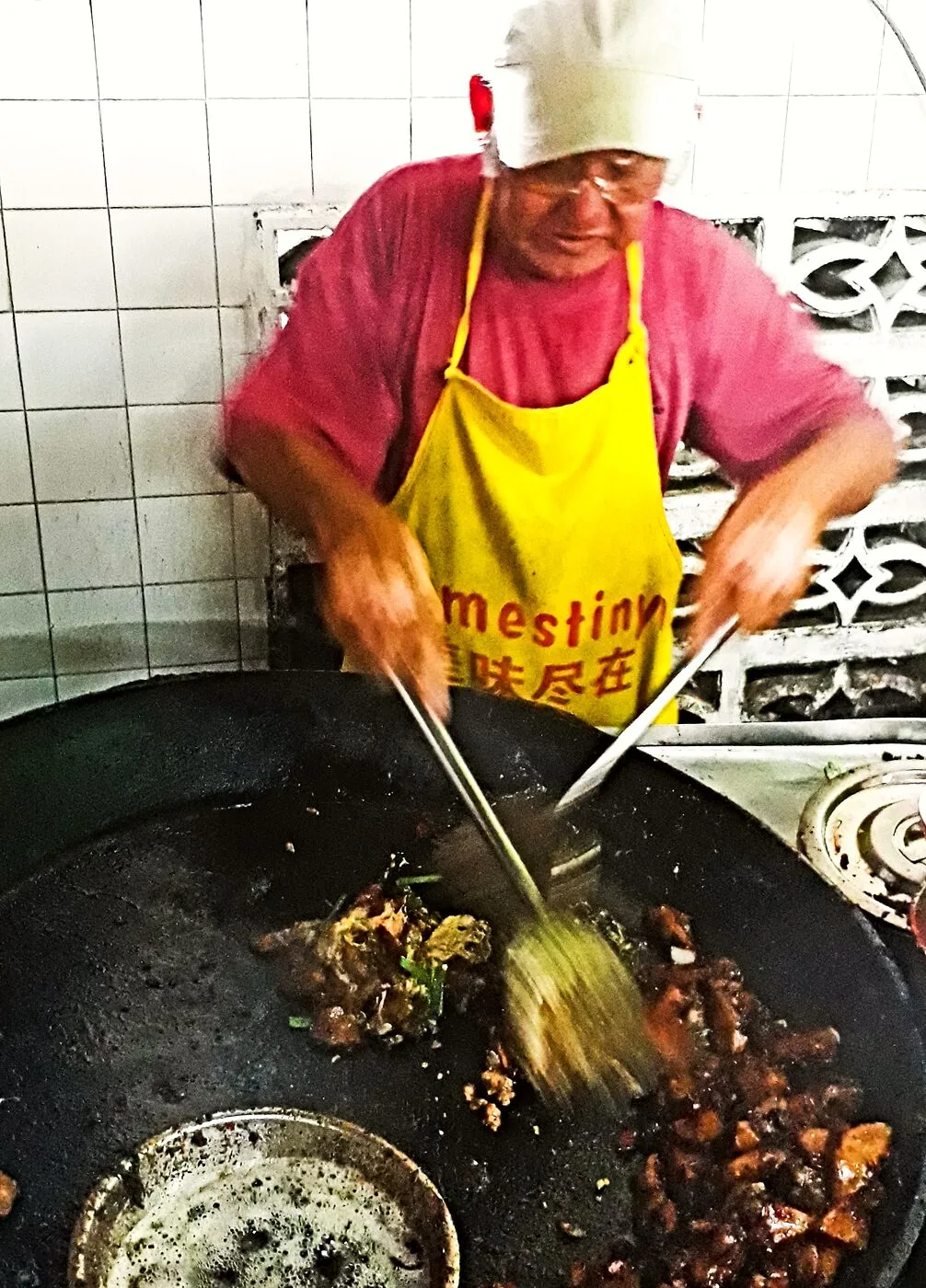 Uncle Chan frying char koay kak at the wok