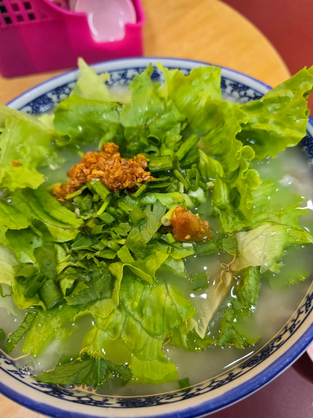 Porridge topped with lettuce and fried pork lard