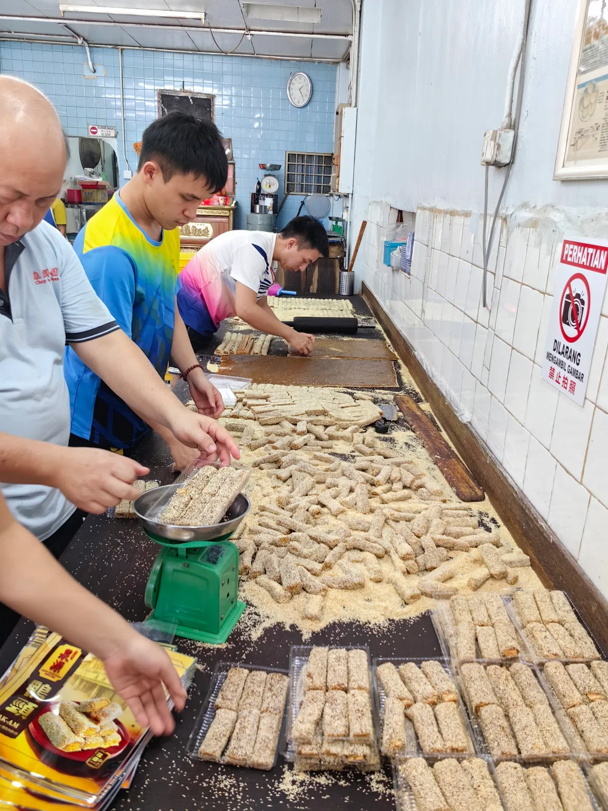 Peanut candy being cut by hand at the work table