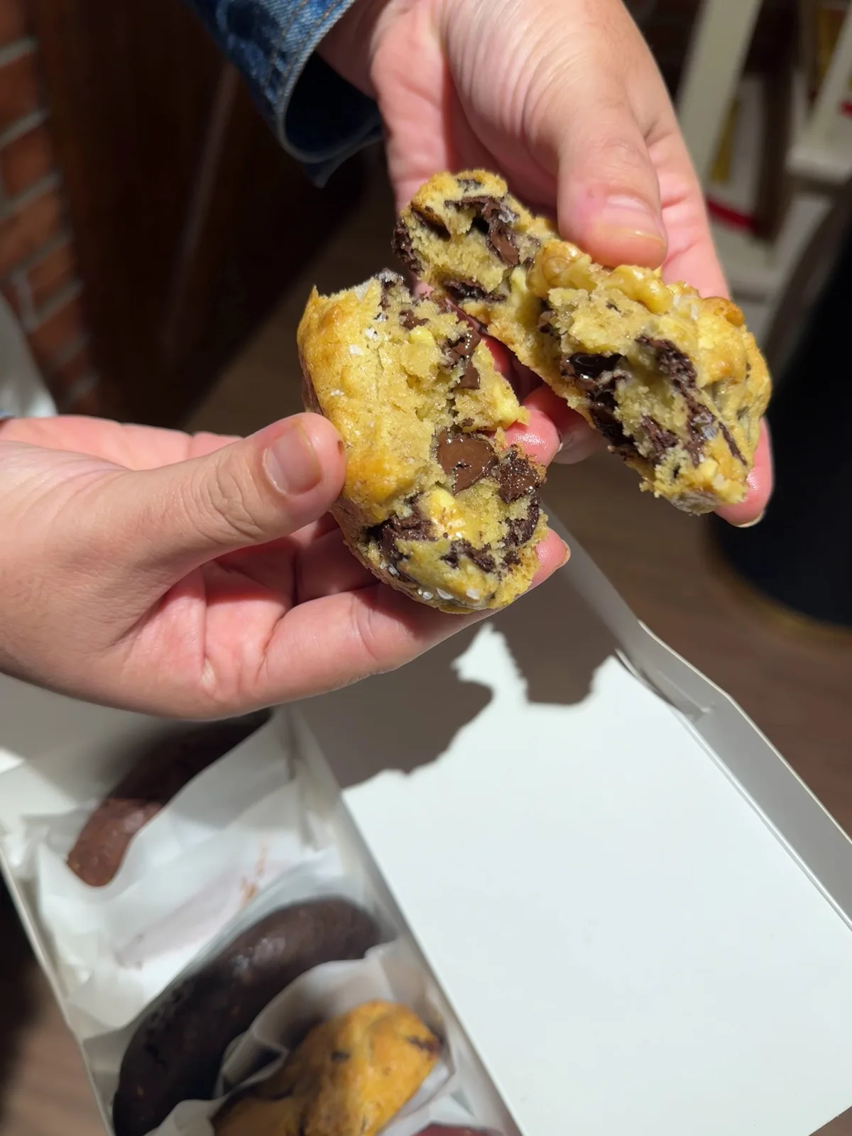 Gooey chocolate chip cookie broken open