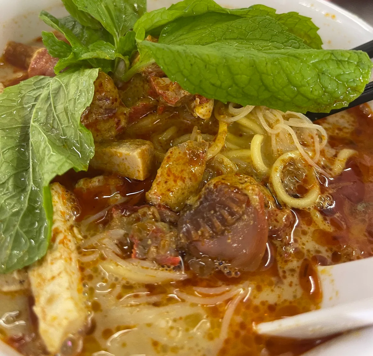 Curry mee with cuttlefish, tofu puffs and mint