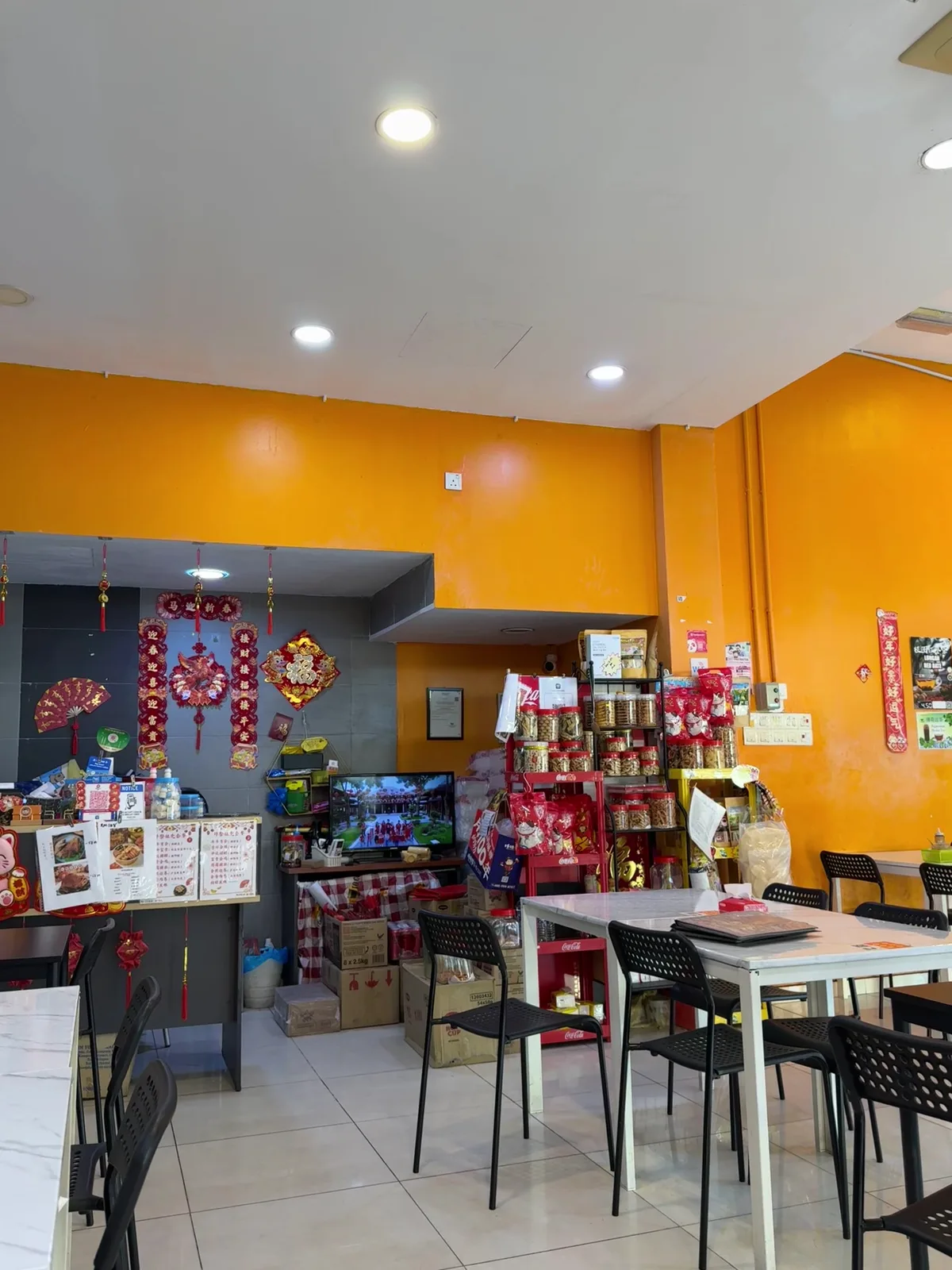 Inside the cafe: orange walls, laminate tables and the drinks counter