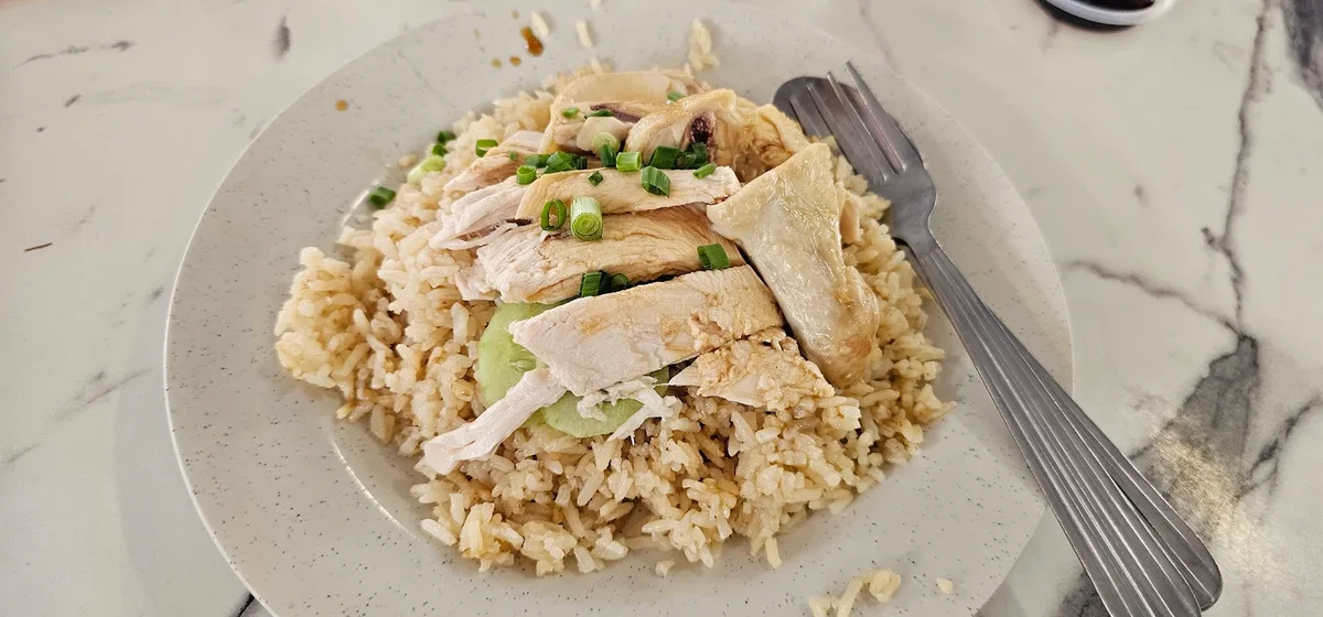 Poached chicken slices over rice