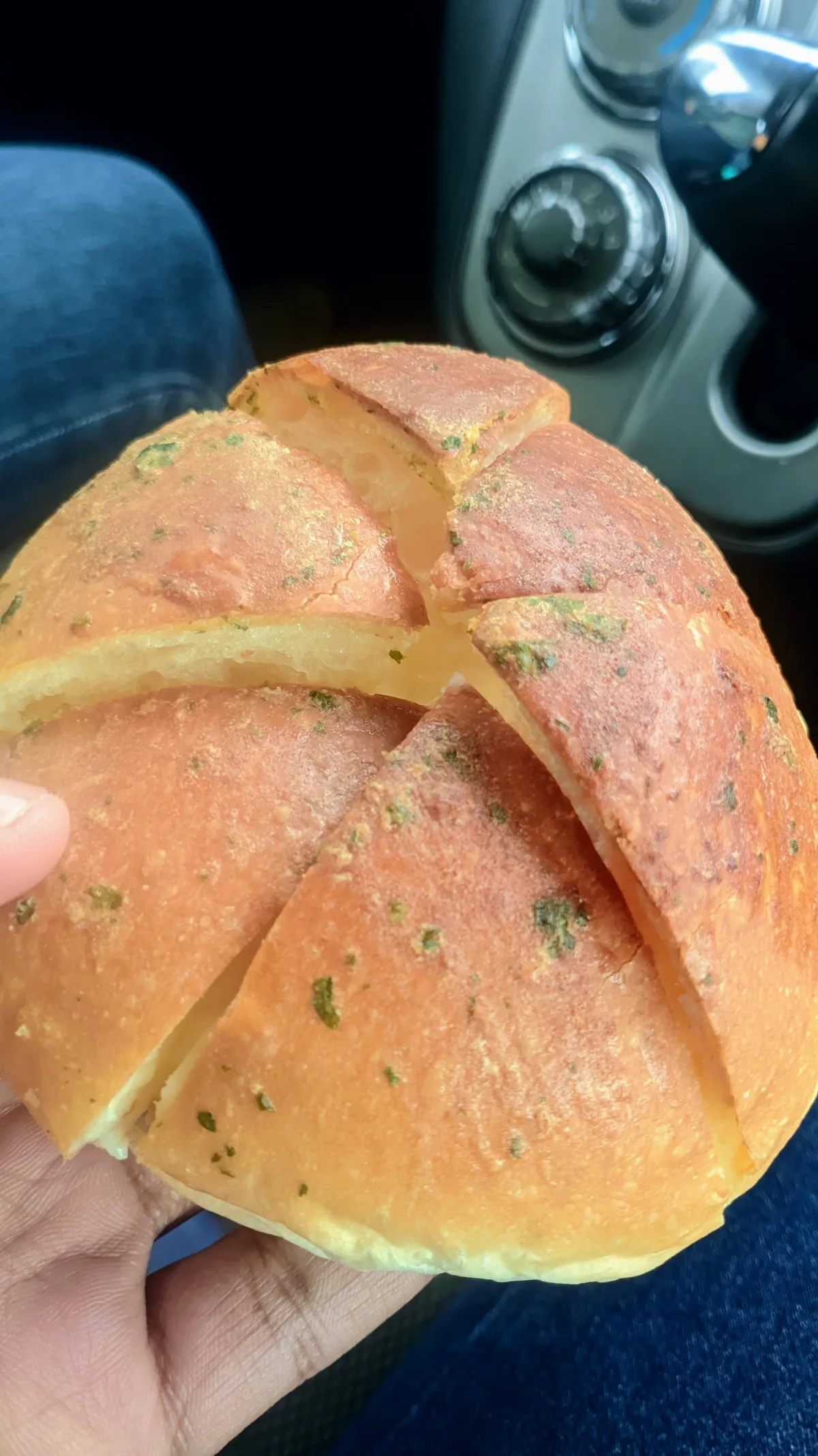 Garlic cheese bun held in hand