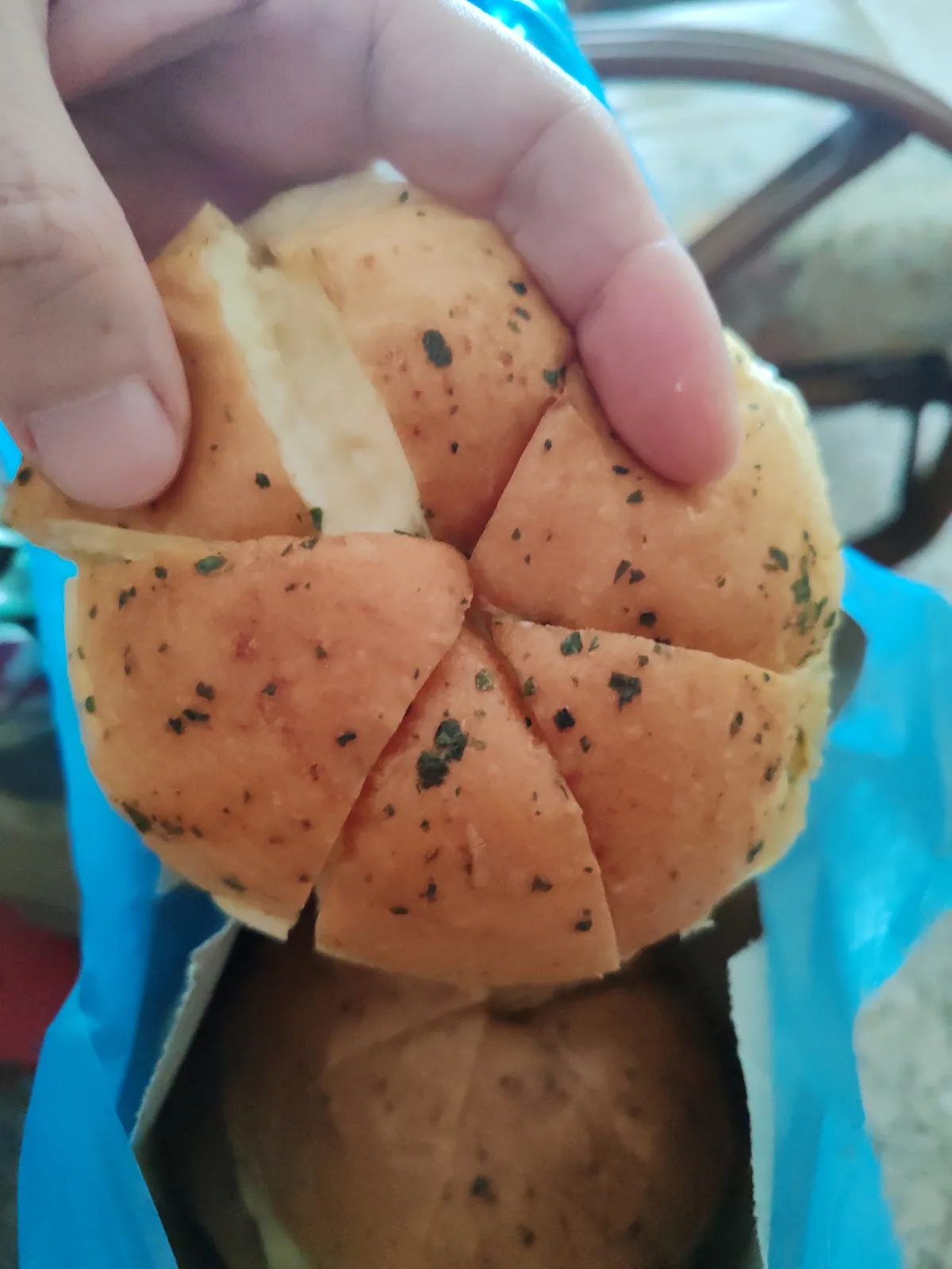 Bun pulled apart showing the melted cheese