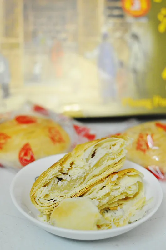 Tau sar piah broken open to show flaky layers and bean filling