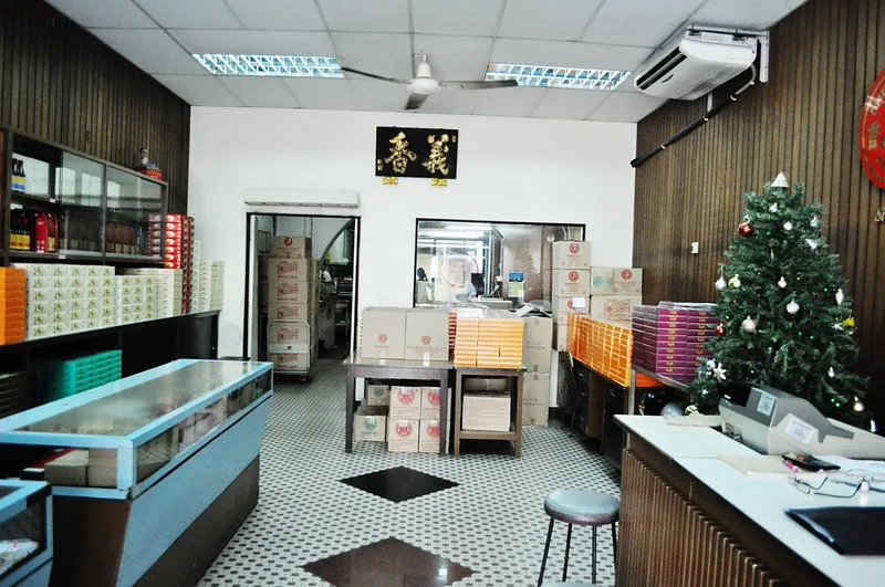 Inside the Ghee Hiang Beach Street shop, display counters and stacked pastry boxes