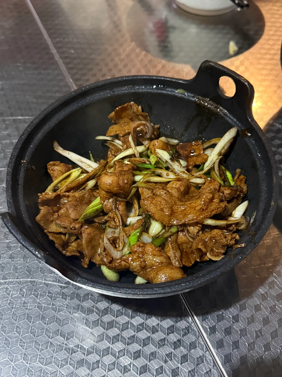 Scallion pork belly in a cast-iron pan
