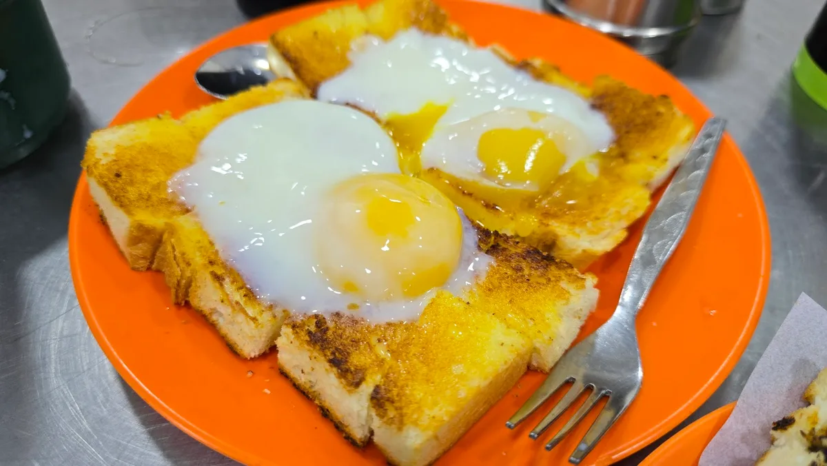 Charcoal roti bakar with runny half-boiled eggs