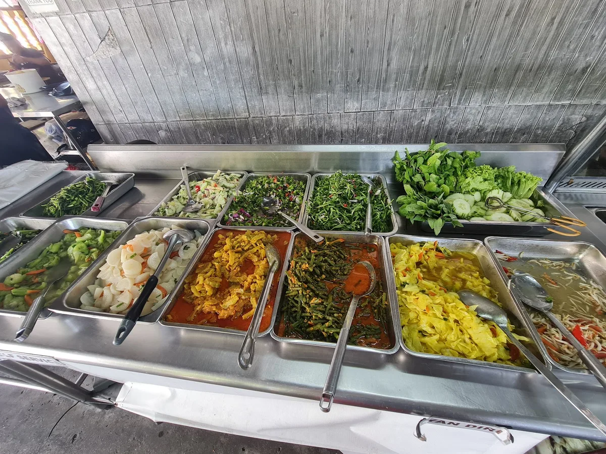 The steam table of curries and vegetables