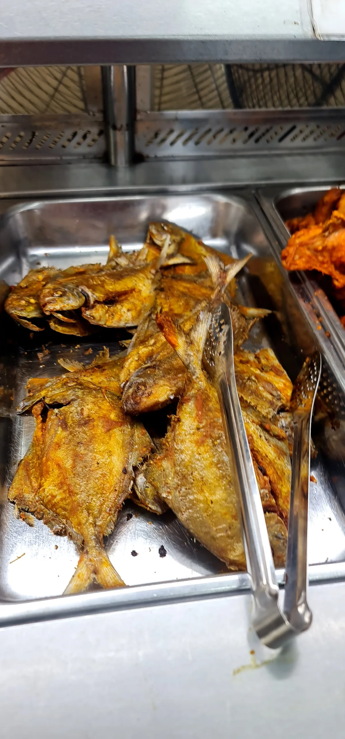 Tray of fried fish on the counter
