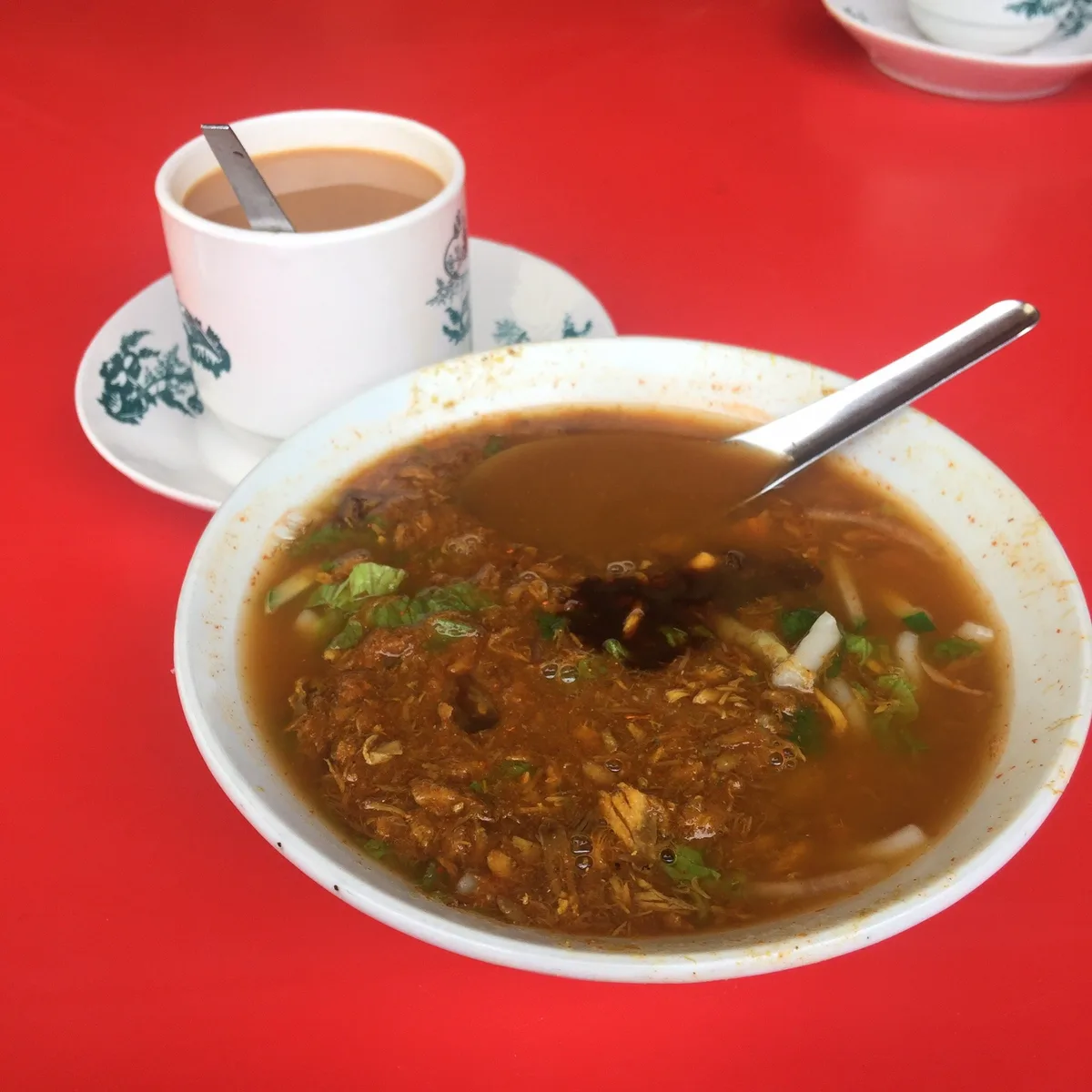 Kim Seng asam laksa — bowl with hae ko and bunga kantan