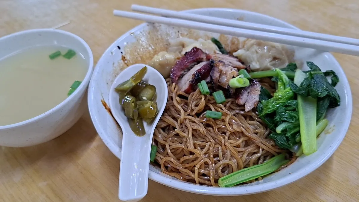 Wan tan mee with its clear soup and a spoon of pickled green chilli