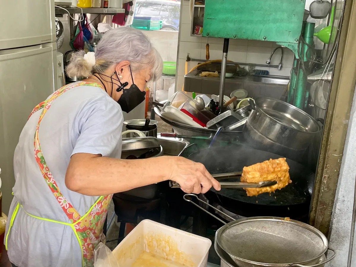 Frying roti babi at the stall