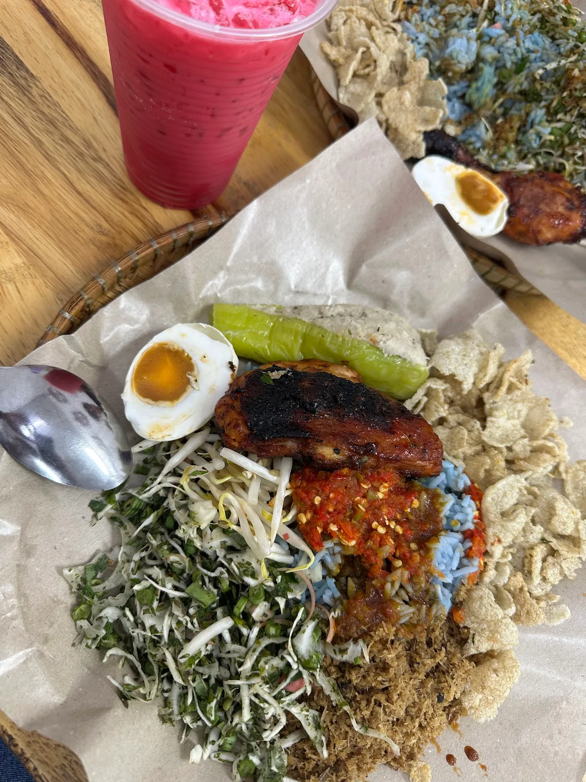 Nasi kerabu with grilled chicken and salted egg