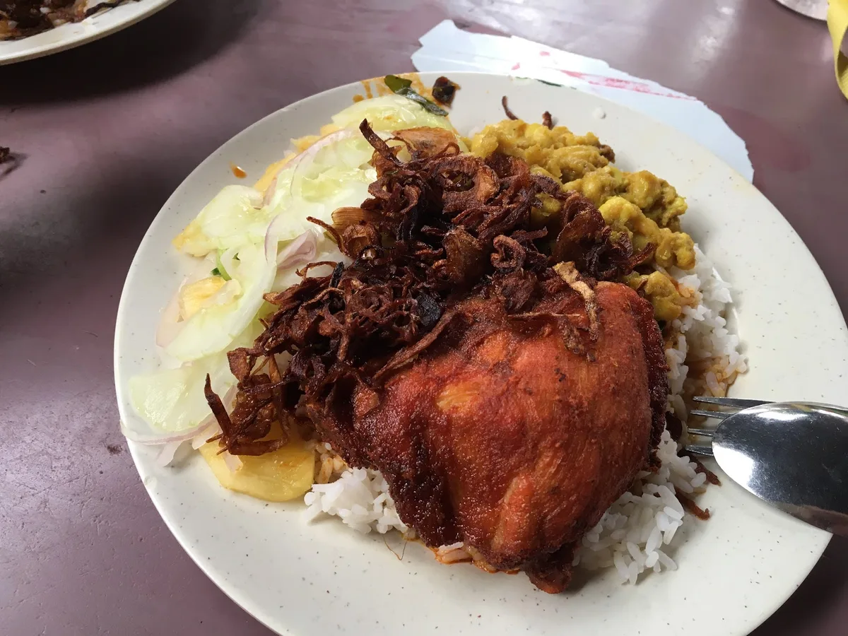 Fried chicken and onions over rice