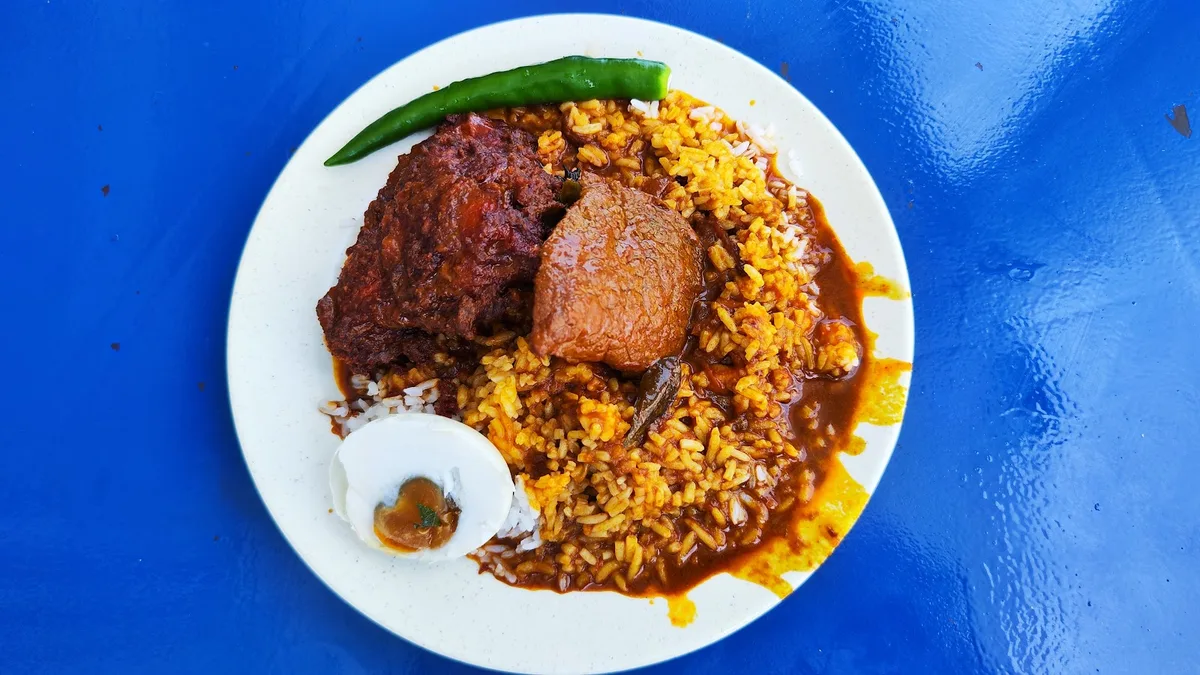 Nasi kandar plate with ayam and banjir curry