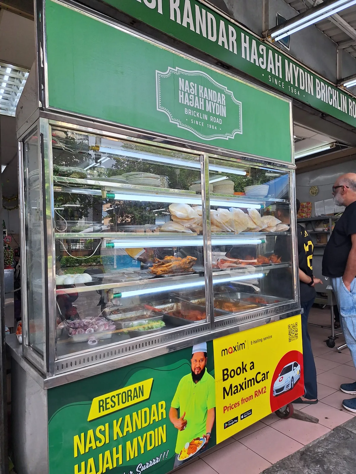 Glass lauk counter under the green Hajah Mydin signboard