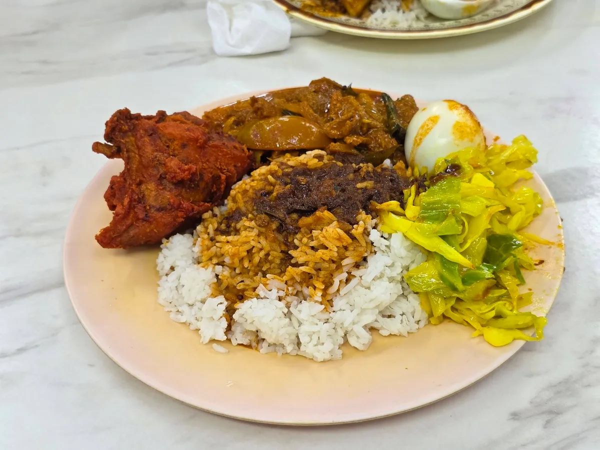 Nasi kandar with fried chicken, egg and cabbage