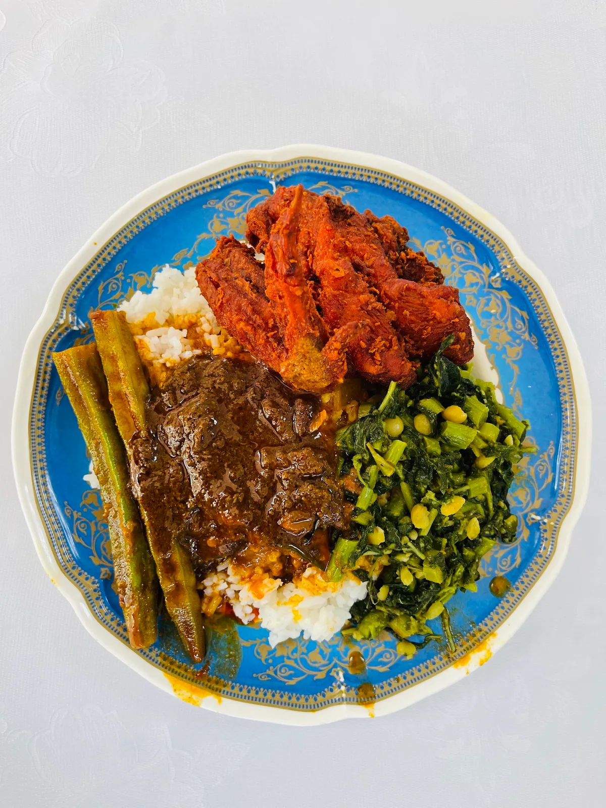 Nasi kandar plate with fried chicken and vegetables