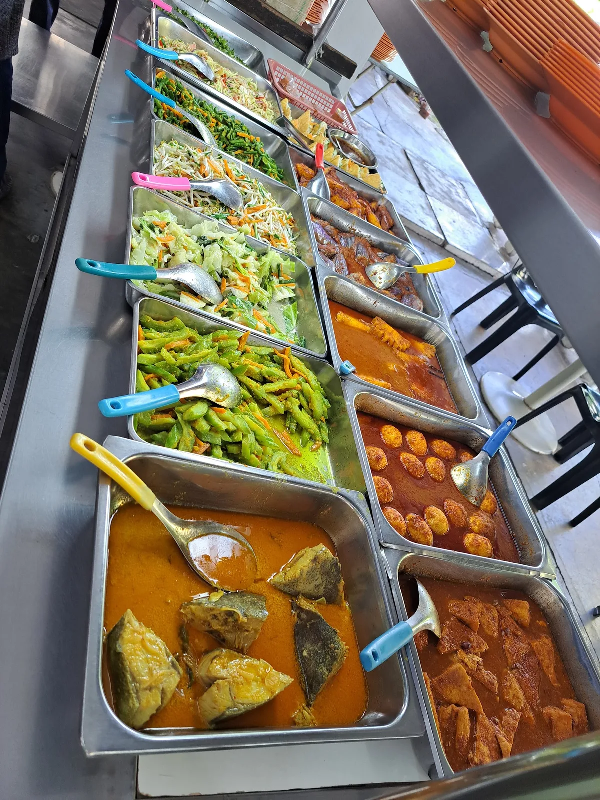 The lauk counter of curries and vegetables