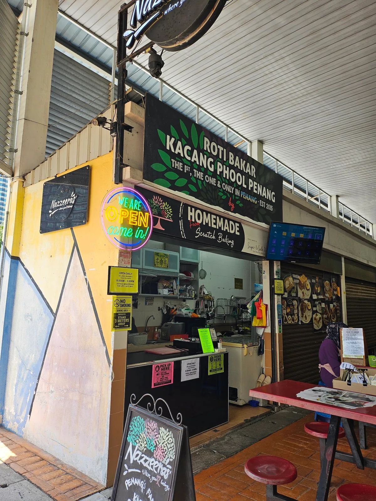 Nazzeera's stall front under the Roti Bakar Kacang Phool Penang signboard