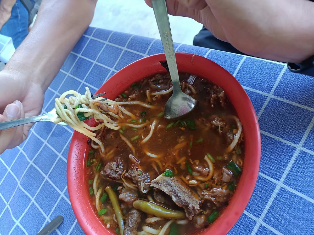 Mee kuah with beef, eaten at the table