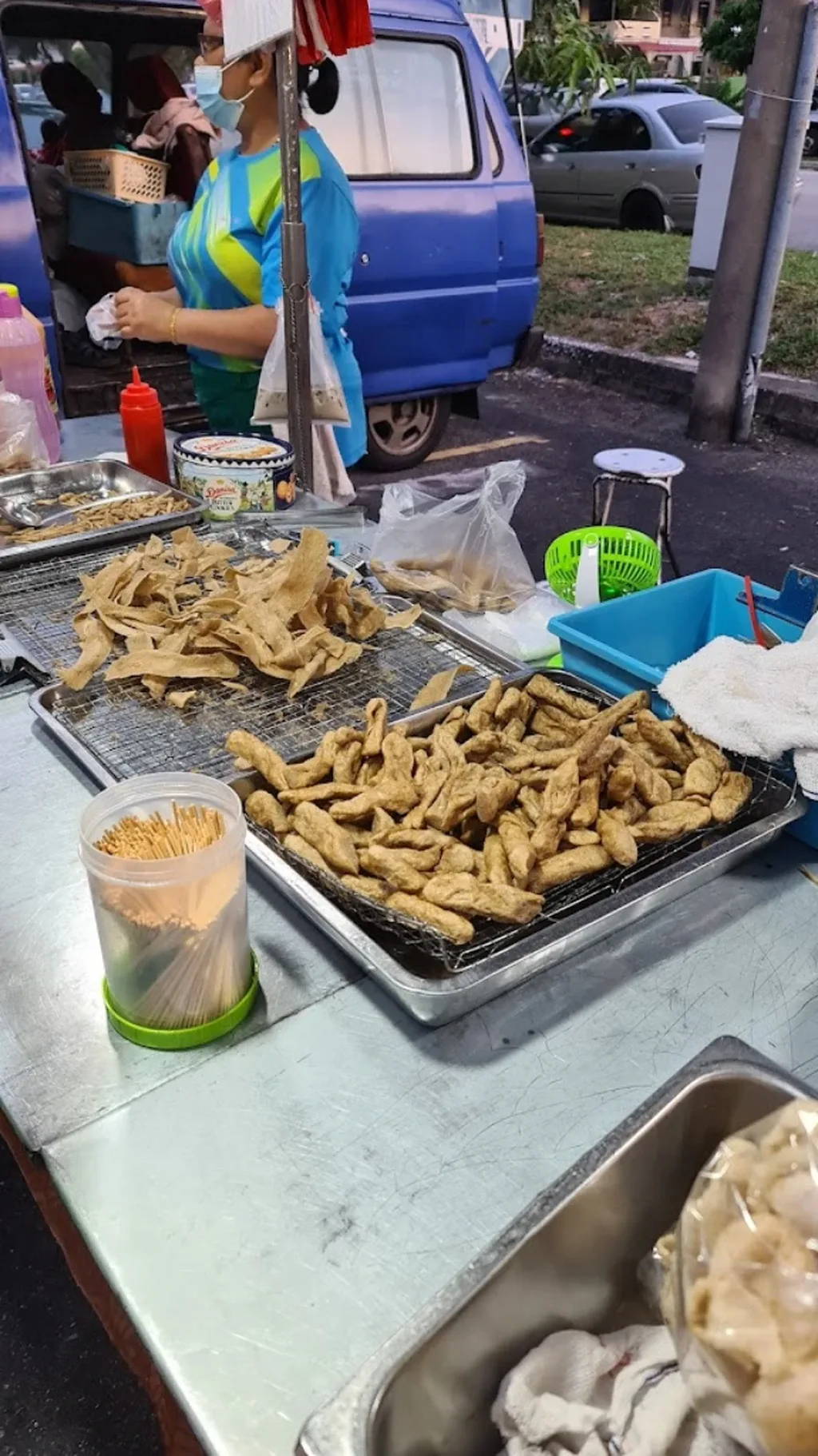 Fried snacks and grilled skewers at a stall