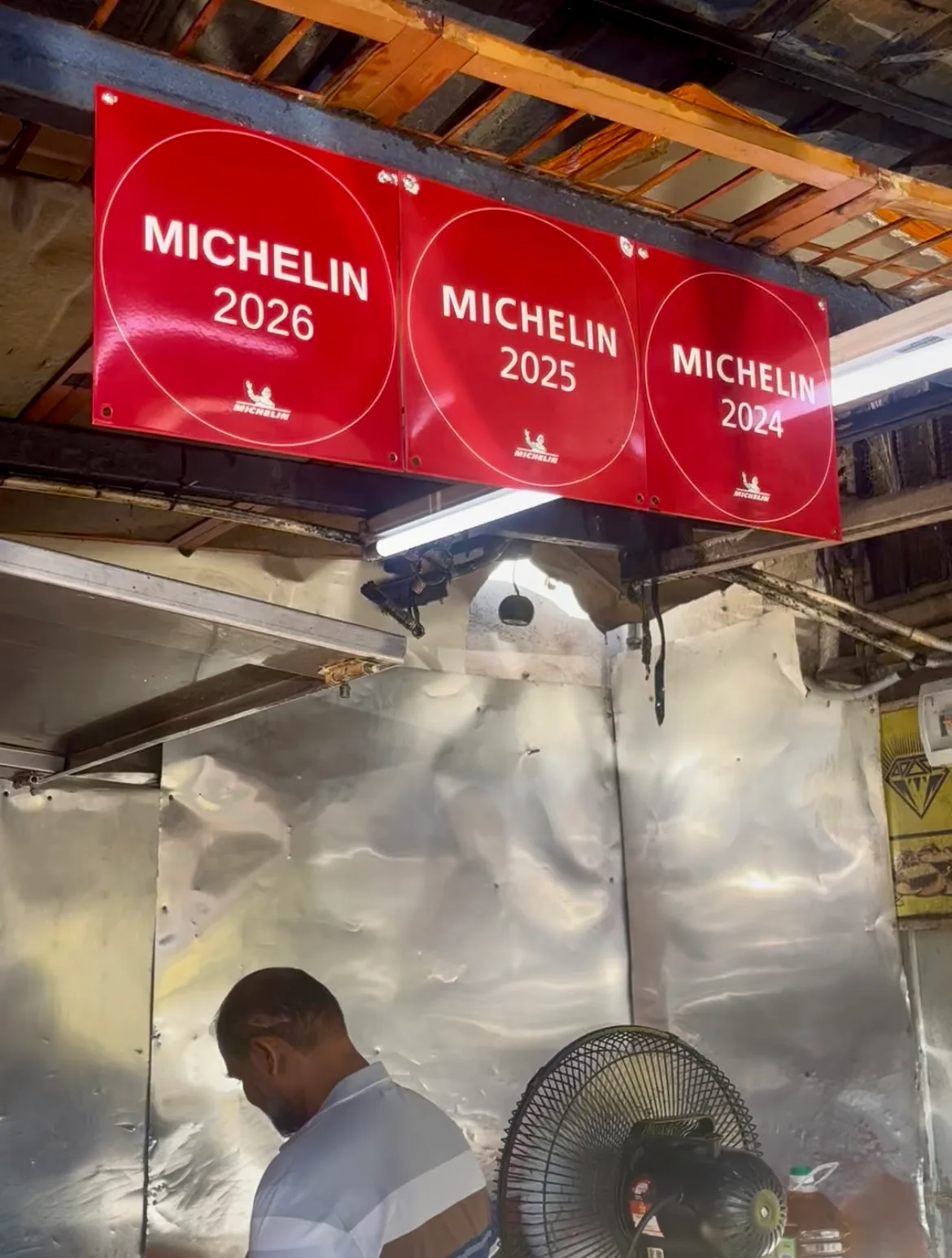 Michelin plaques for 2024, 2025 and 2026 over the fryer