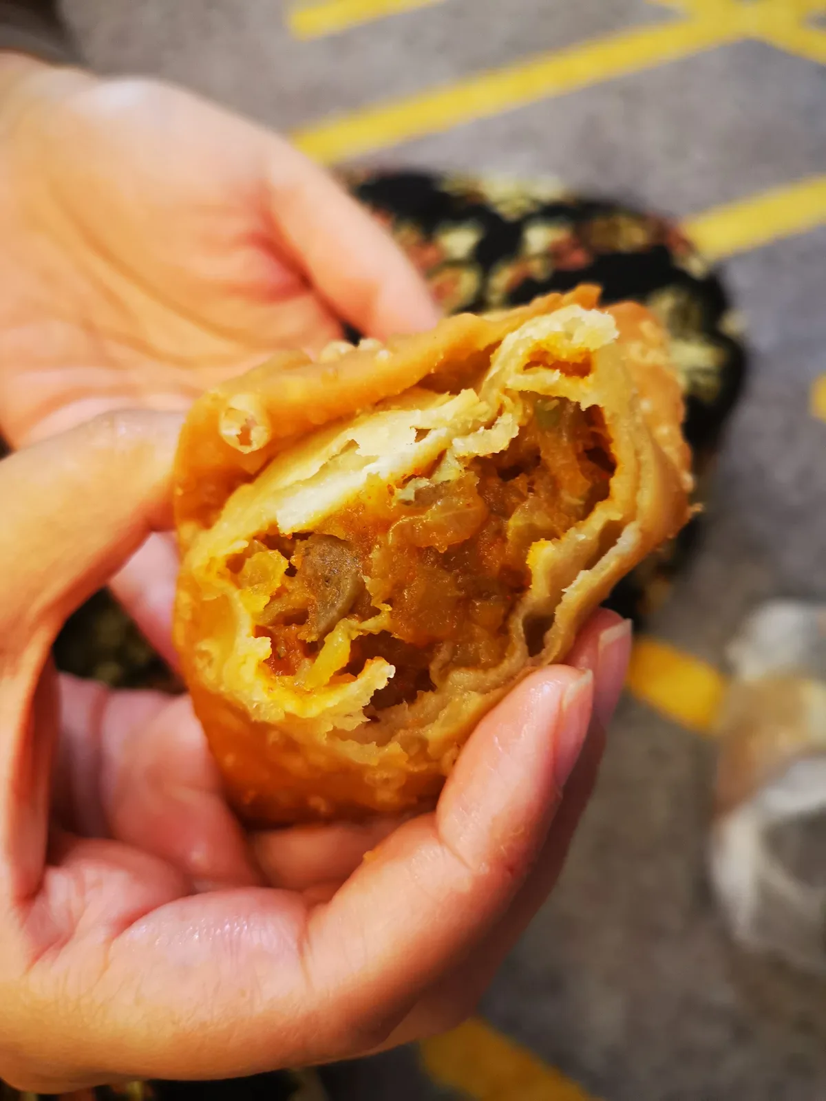 Samosa broken open to the spiced filling