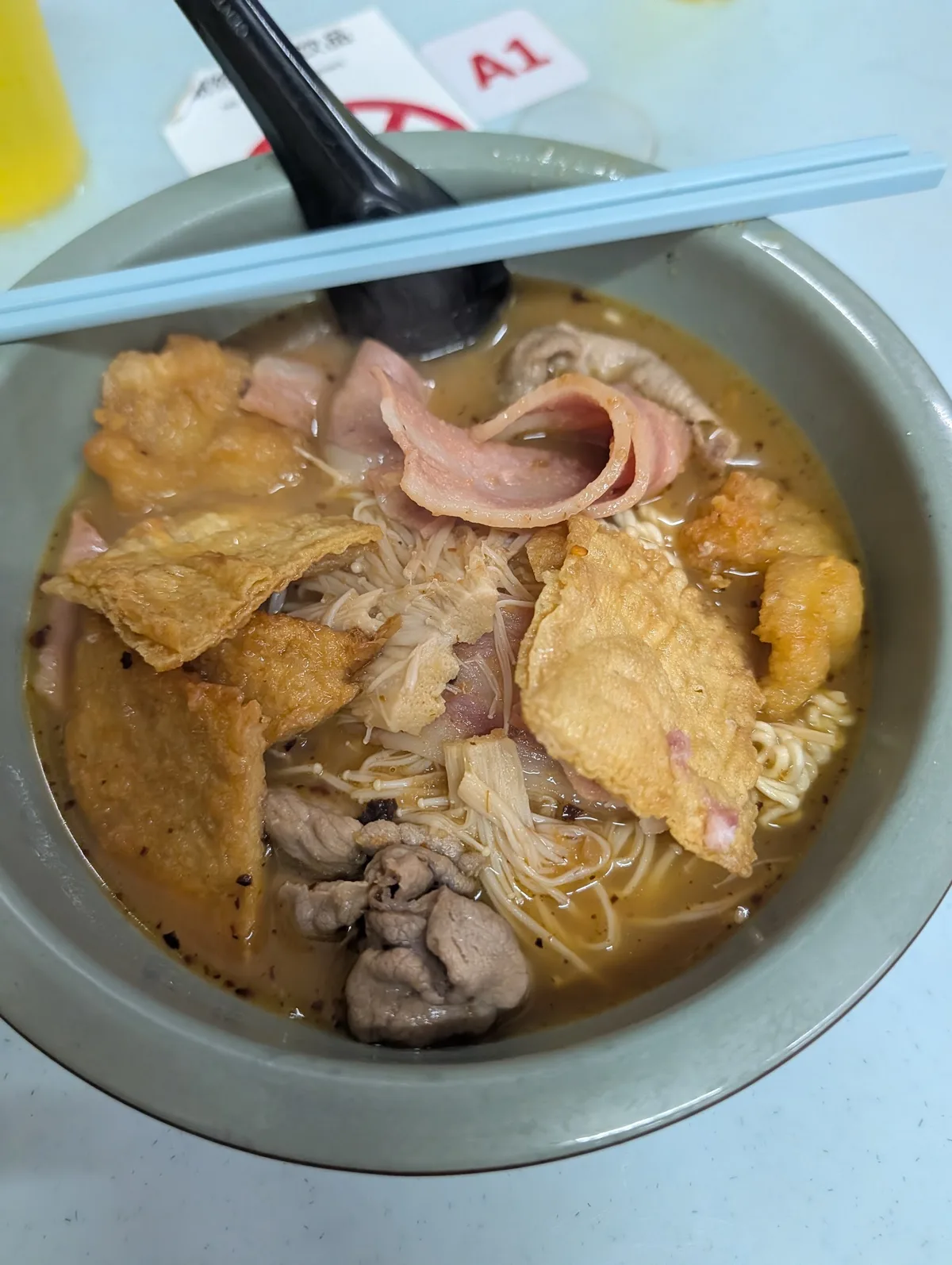 Tom yam noodles with fish cake and liver