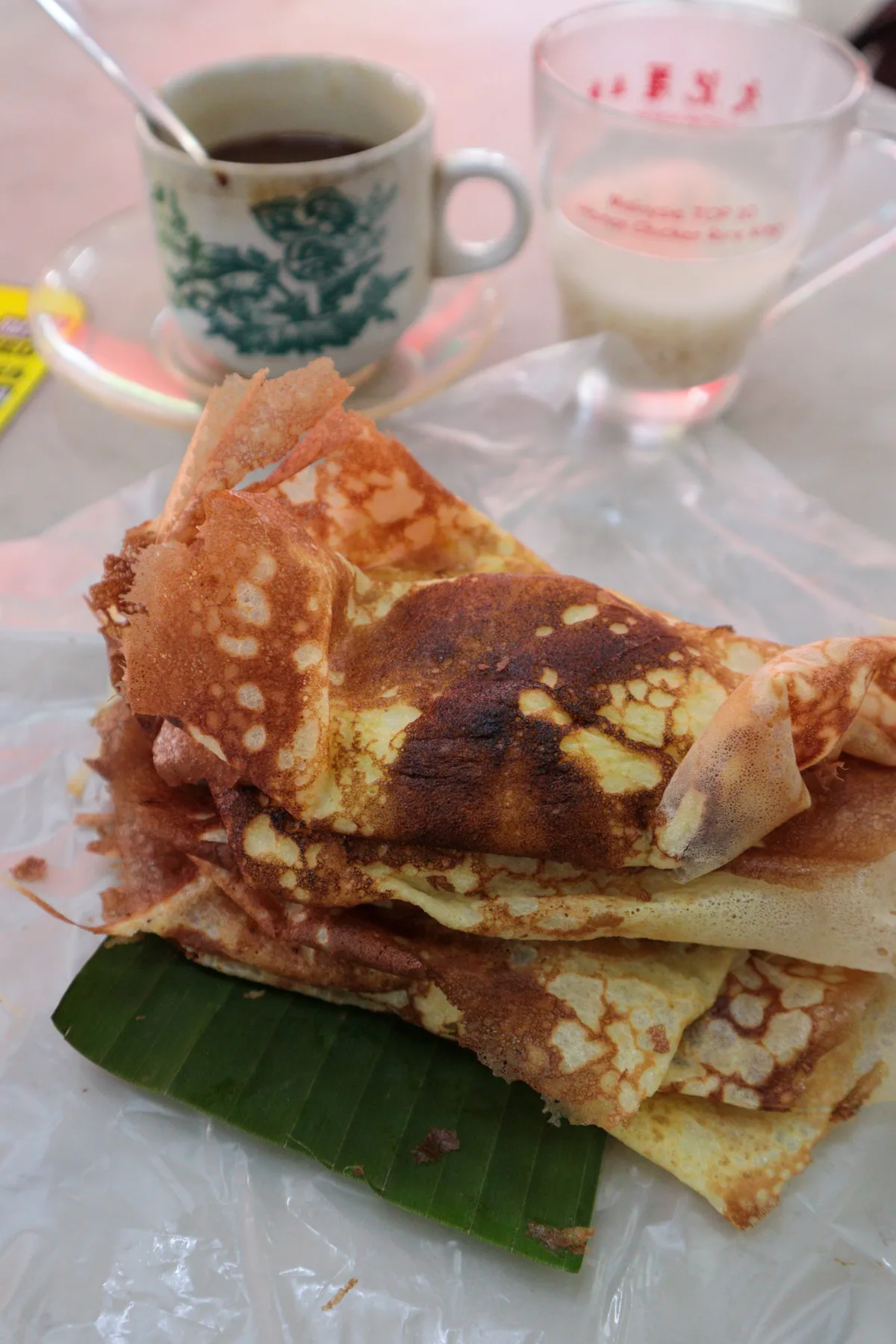 Apom wrapped in banana leaf