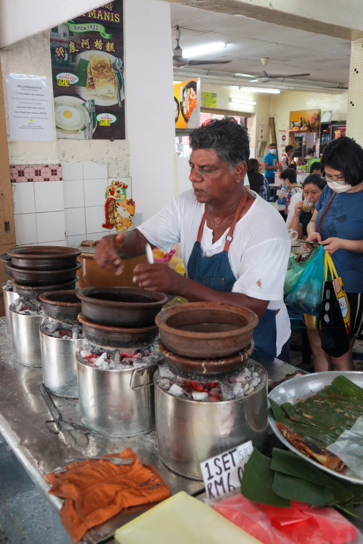 Stacked claypots at the apom stall
