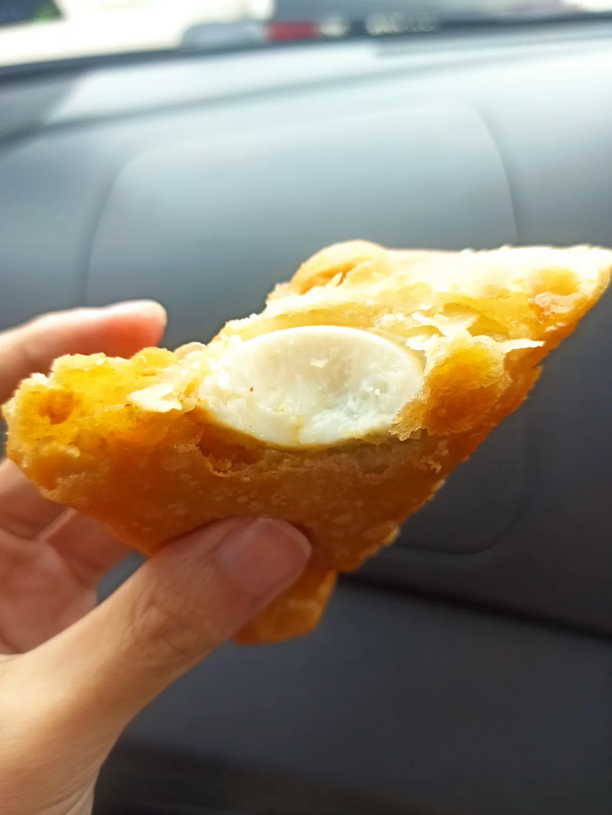 Samosa broken open in hand